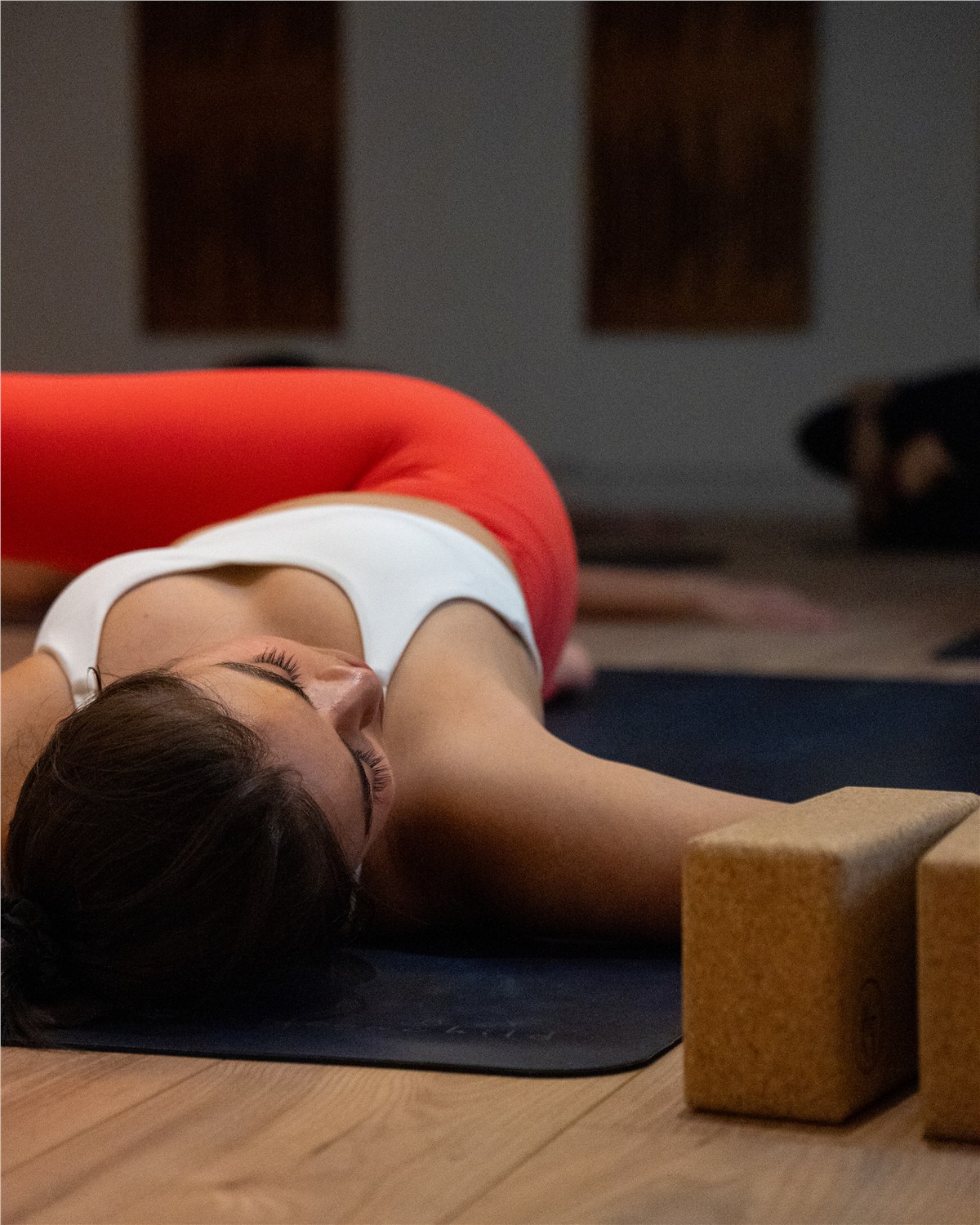 Hilary resting in a supported yin posture at The Space Paris